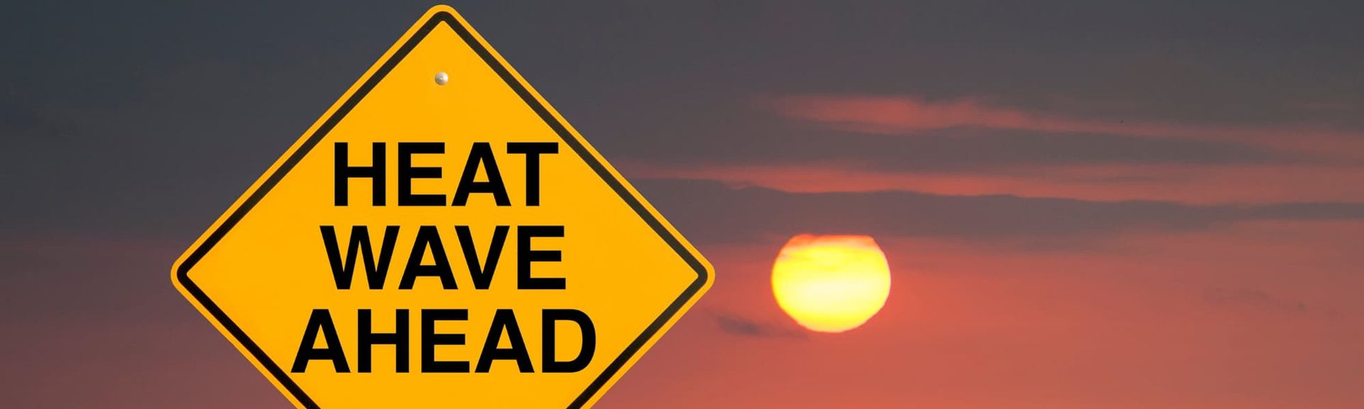 A yellow diamond-shaped road sign reads 