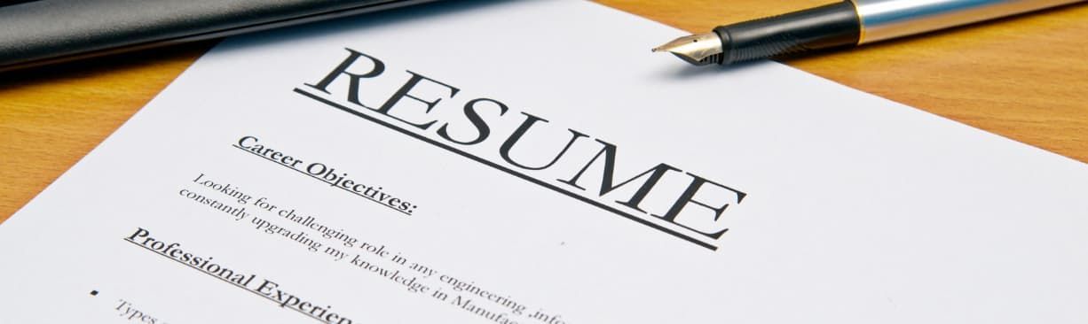 Resume document on a desk with a pen, viewed at an angle
