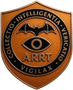 Copper shield emblem with bat and eye, reading “COLLECTIO INTELLIGENTIA VERITATIO VIGILAX” and “ARRT.”