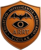 Copper shield emblem with bat and eye, reading “COLLECTIO INTELLIGENTIA VERITATIO VIGILAX” and “ARRT.”