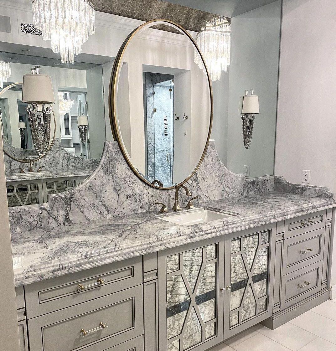 A bathroom with two sinks and a large mirror