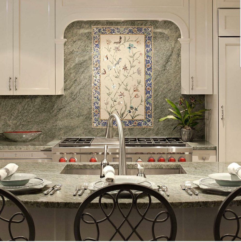 A kitchen with a sink and a stove top oven