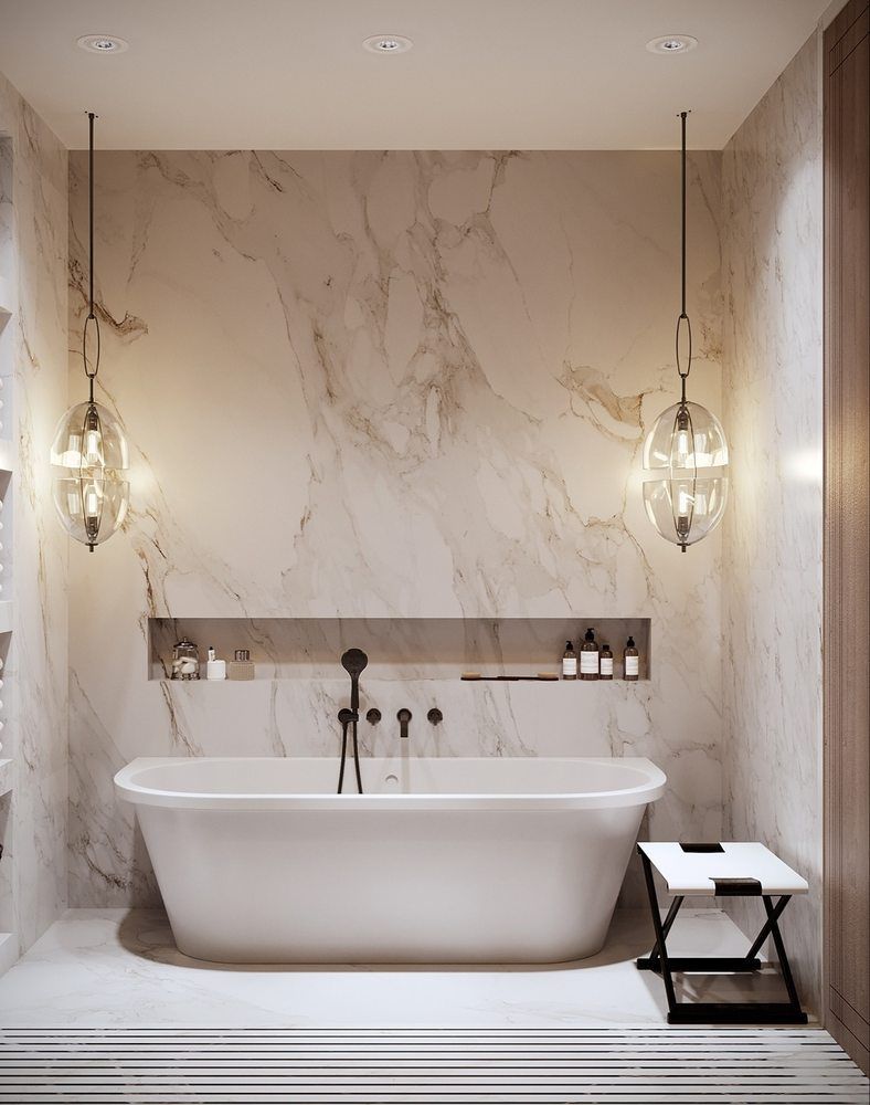 There is a bathtub in the bathroom with a marble wall.