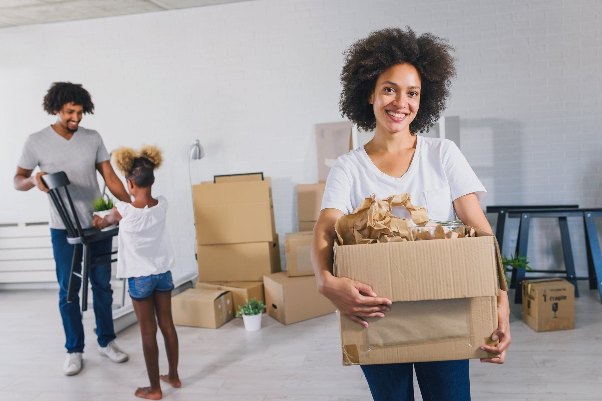 Young African-american Family Unpacking and Cleaning.