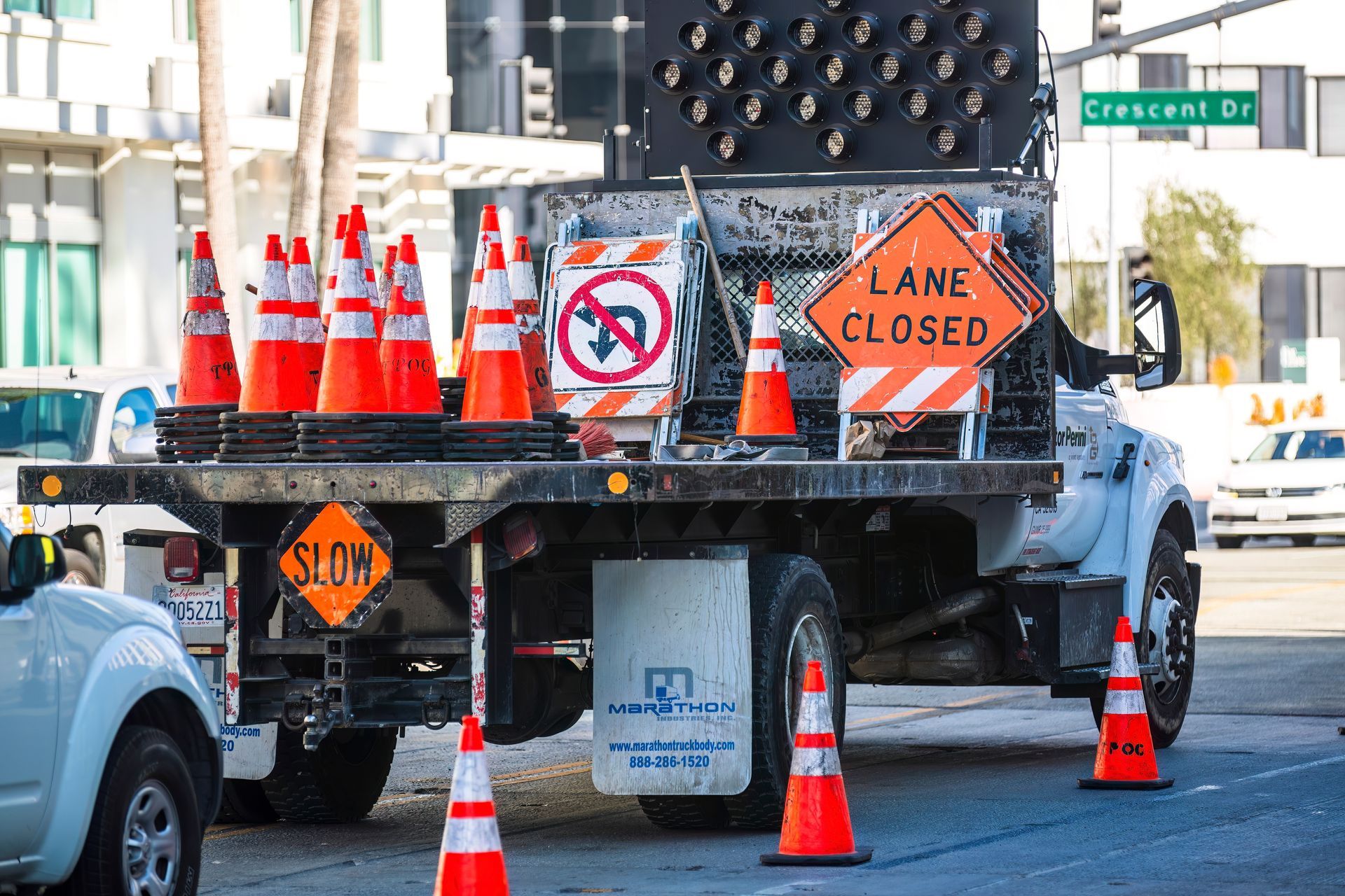A truck with a lane closed sign on the back of it.