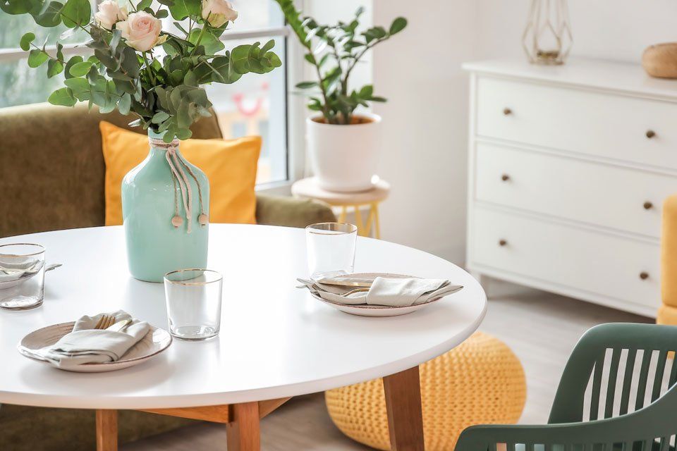 There is a vase of flowers on the table in the living room.