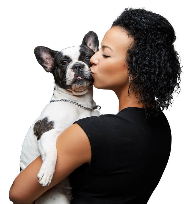A woman kisses a black and white dog on the cheek