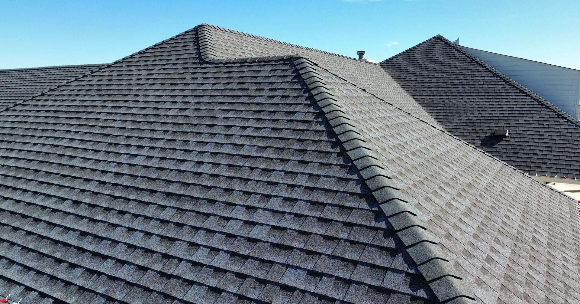 A close up of a roof with a blue sky in the background.