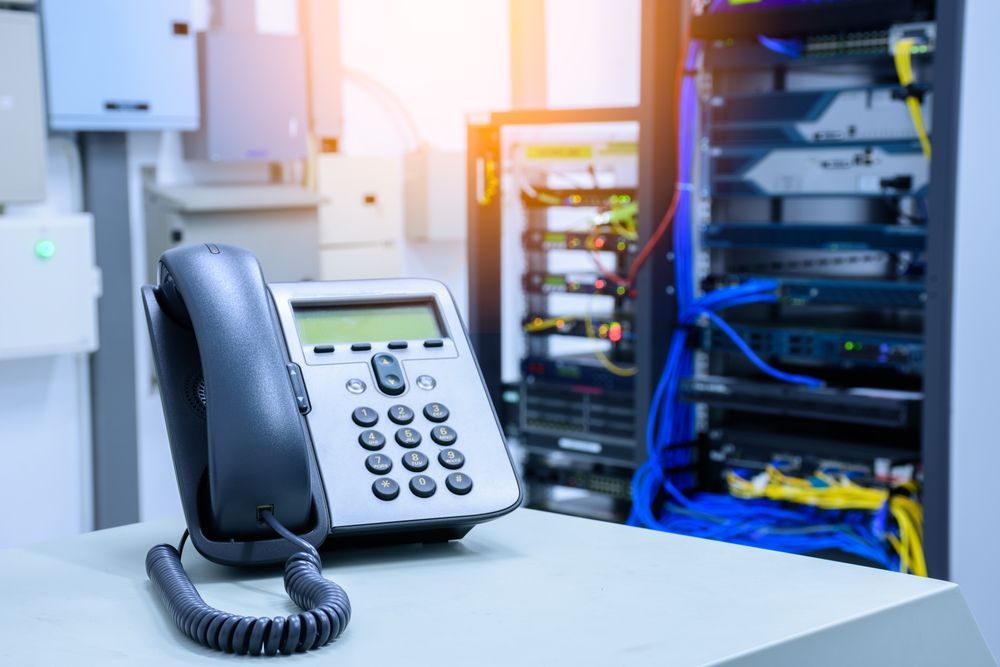 Desk Phone on a White Table in a Data Center — Pacific Telephone & Data In Cessnock, NSW