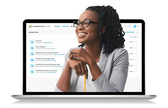 Smiling Person at Laptop With a Document List on Screen — Pacific Telephone & Data In Cardiff, NSW