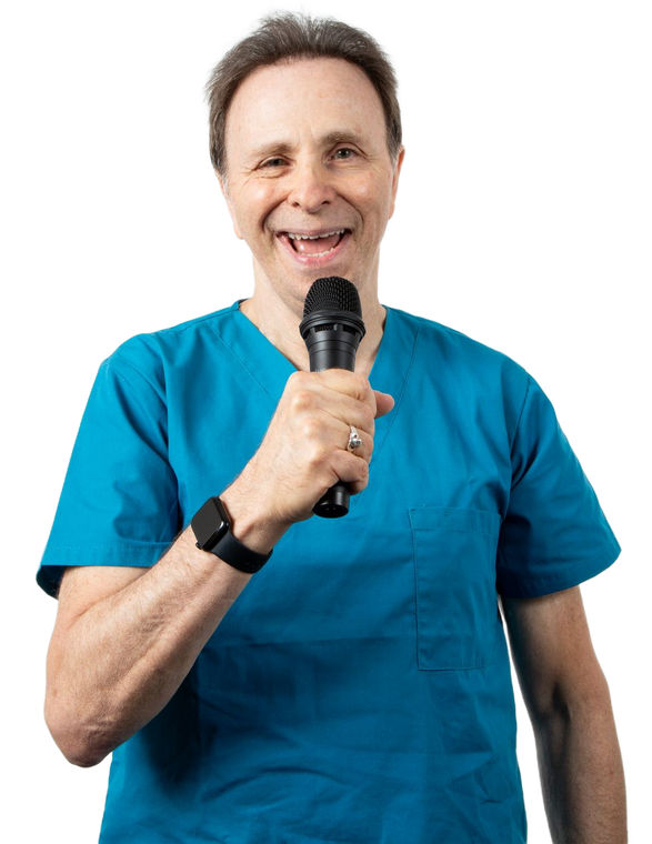 Smiling person in blue scrubs holding a microphone against a white background