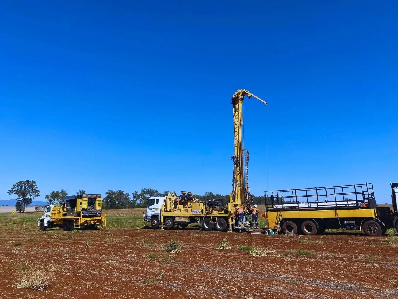 Drilling Rig on a Red-soiled Field Under a Blue Sky — Local Drilling Services In Esk, QLD