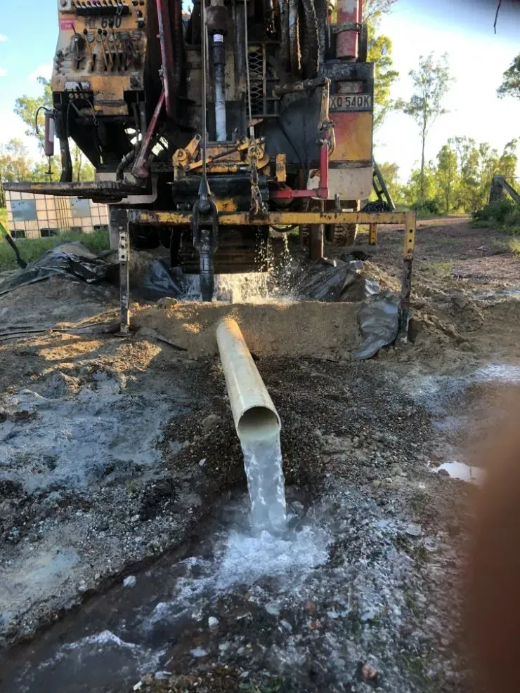 A Drilling Rig Pumps Water and Sediment Into a Pipe — Local Drilling Services In Nanango, QLD