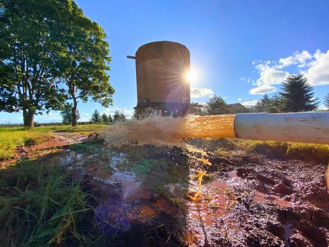 Water Gushing From a Cylindrical Structure in a Field — Local Drilling Services In Yarraman, QLD