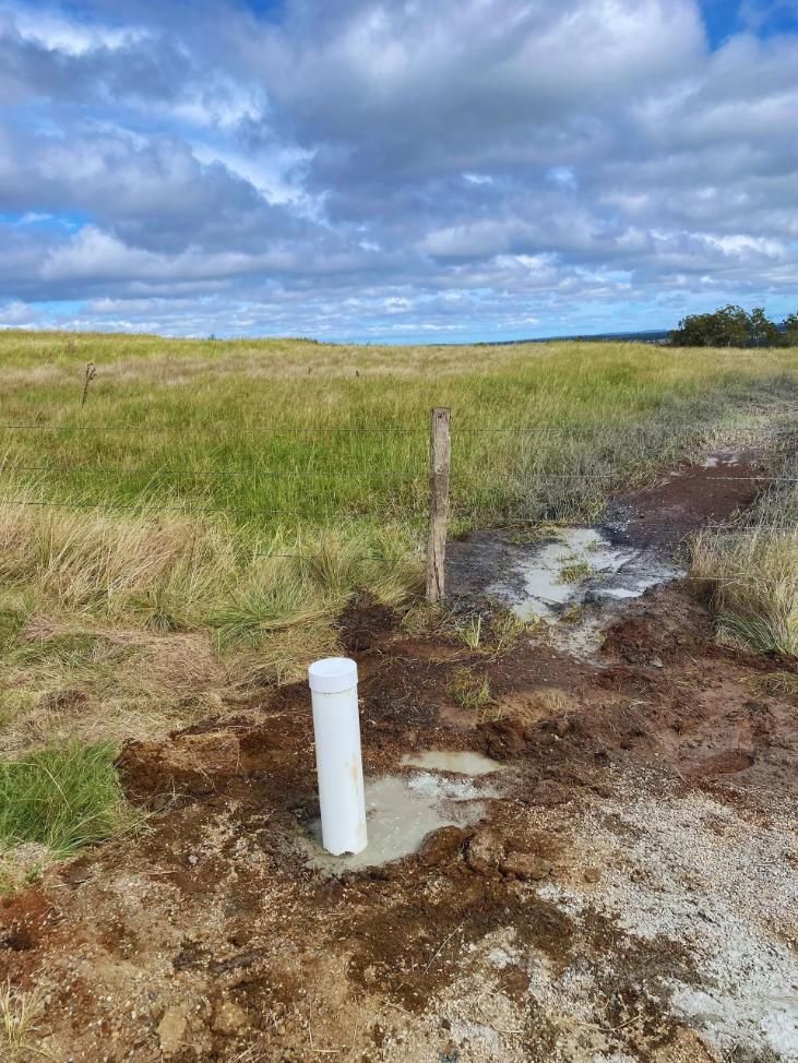 White Pipe Emerging From Concrete — Local Drilling Services In North Burnett, QLD