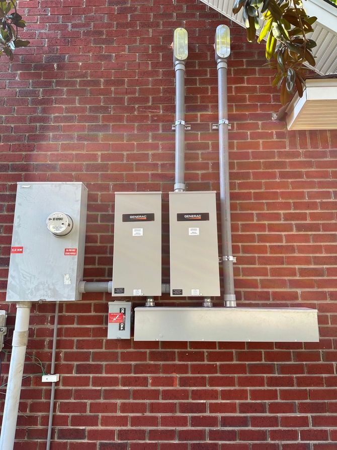 Brick wall with electrical meter boxes, conduit, and a beige utility cabinet.