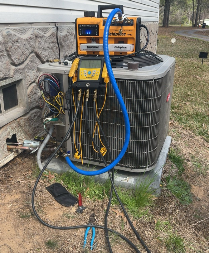 Brick wall with electrical meter boxes, conduit, and a beige utility cabinet.