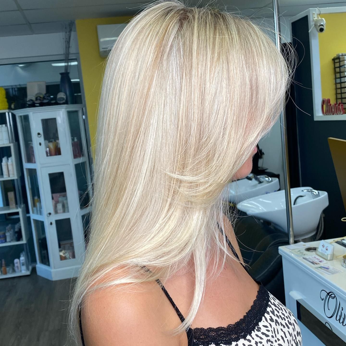 Blonde Woman In Profile With Long Layered Hair In A Salon Setting — Oh So Blonde Hair Studio in Kawana, QLD