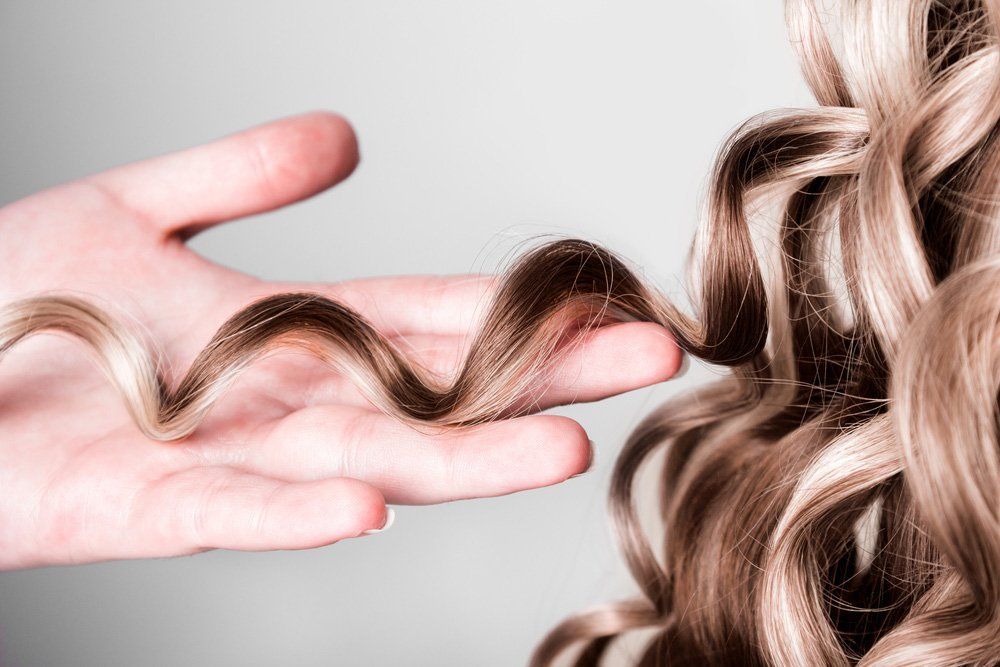Blond-haired Woman With a Slight Smile and Red Lipstick — Oh So Blonde Hair Studio in Buddina, QLD