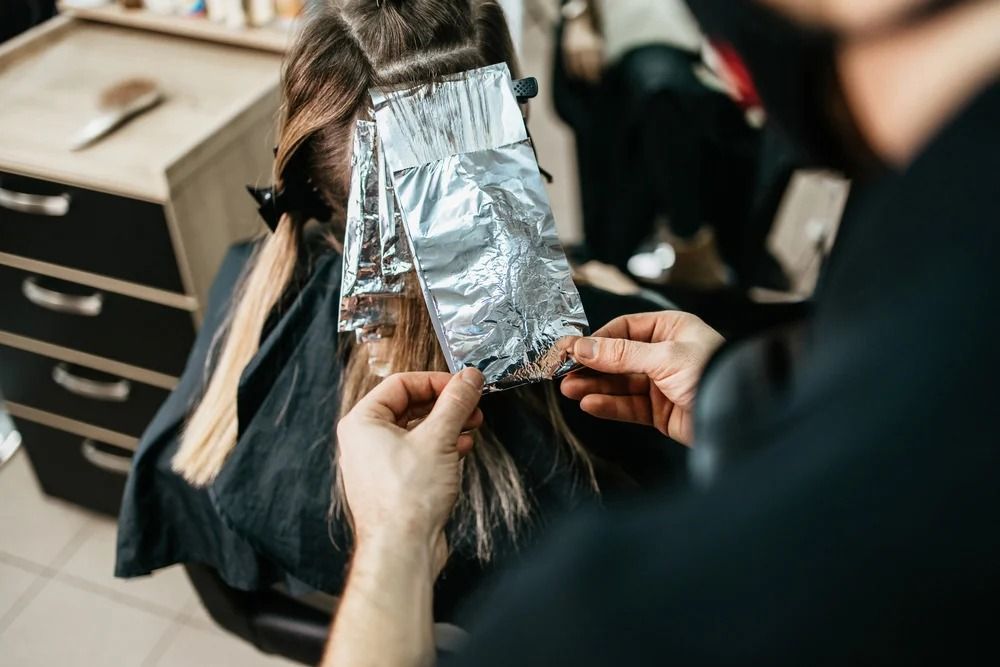 Hairdresser Applying Highlights With Foil— Oh So Blonde Hair Studio in Buddina, QLD