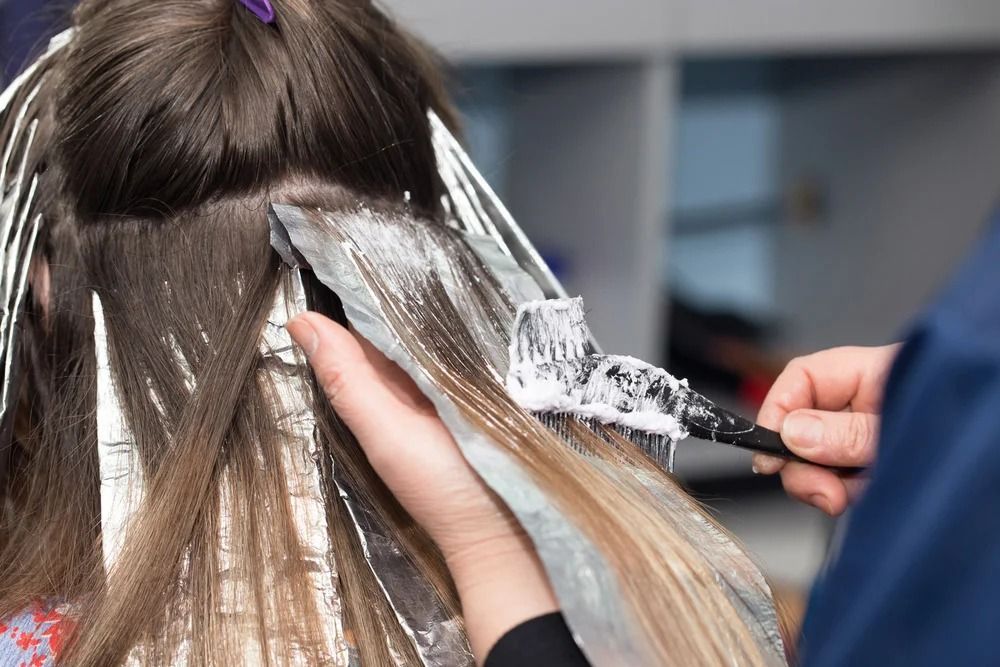 Hairdresser Applying Bleach — Oh So Blonde Hair Studio in Buddina, QLD