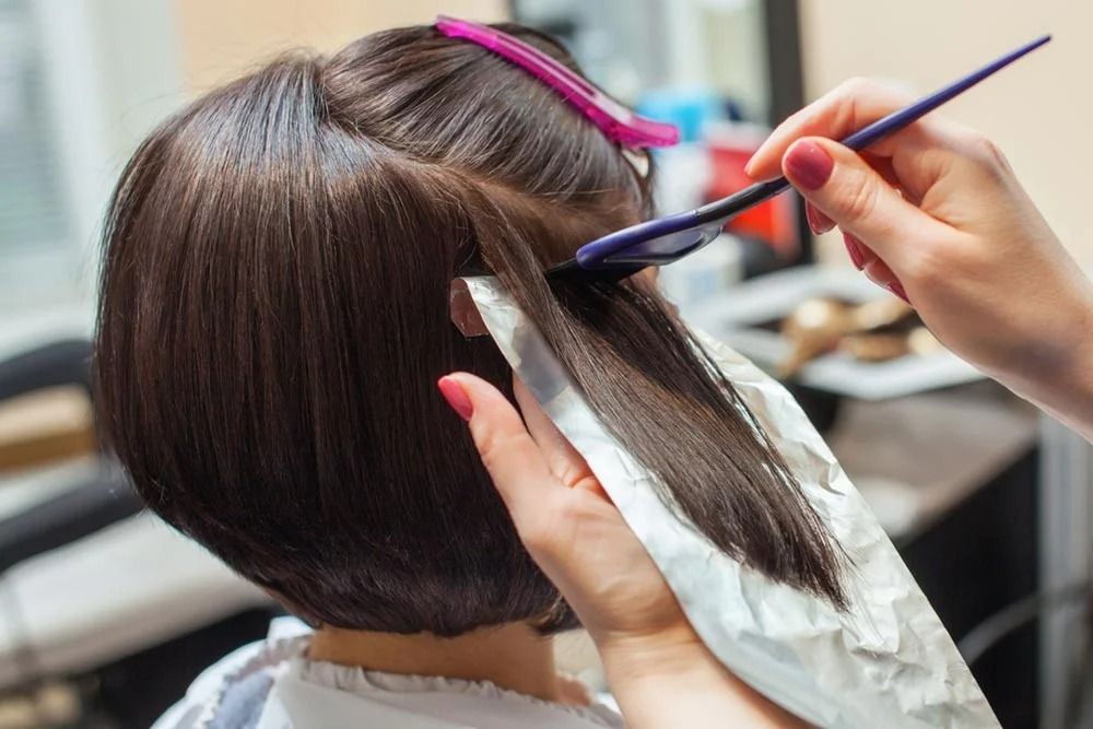 Hairdresser Applying Hair Dye — Oh So Blonde Hair Studio in Buddina, QLD
