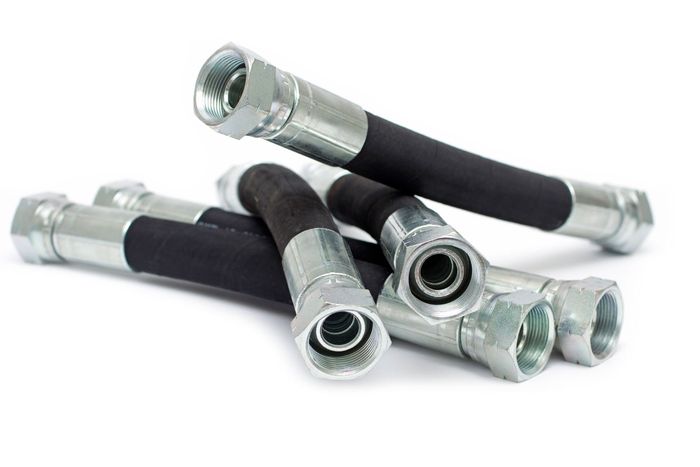 A Bunch Of Hydraulic Hoses Are Stacked On Top Of Each Other On A White Background — Lake City, GA — A-1 Hydraulics A Bunch Of Hydraulic Hoses Are Stacked On Top Of Each Other On A White Background — Lake City, GA — A-1 Hydraulics