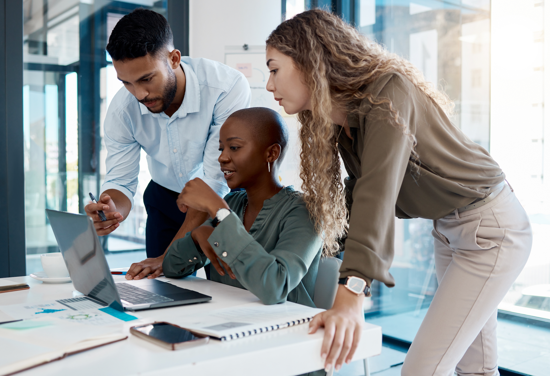 A group of people are looking at a laptop computer.