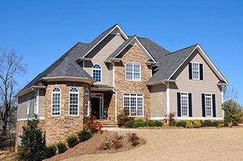 A large house with a lot of windows and a gray roof
