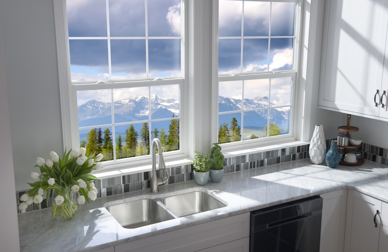 A kitchen with a sink and a window with a view of the mountains.