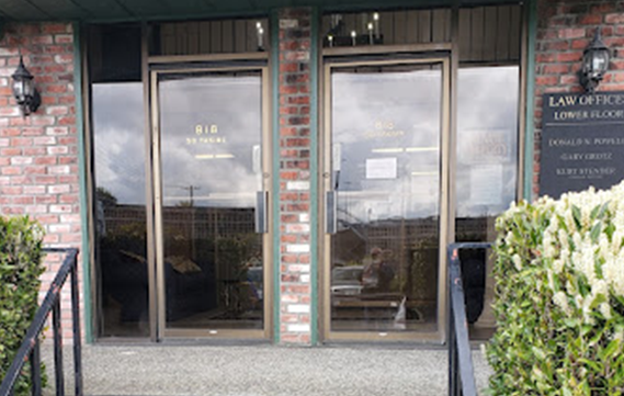 A brick building with a sign that says law office on it
