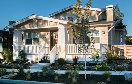 the front of a house with a porch and stairs