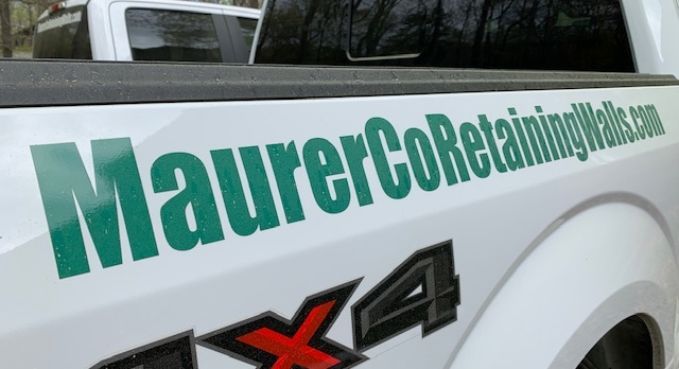 Green MaurerCoRebasingHeights.com decal on a white pickup truck door, with a 4x4 badge.