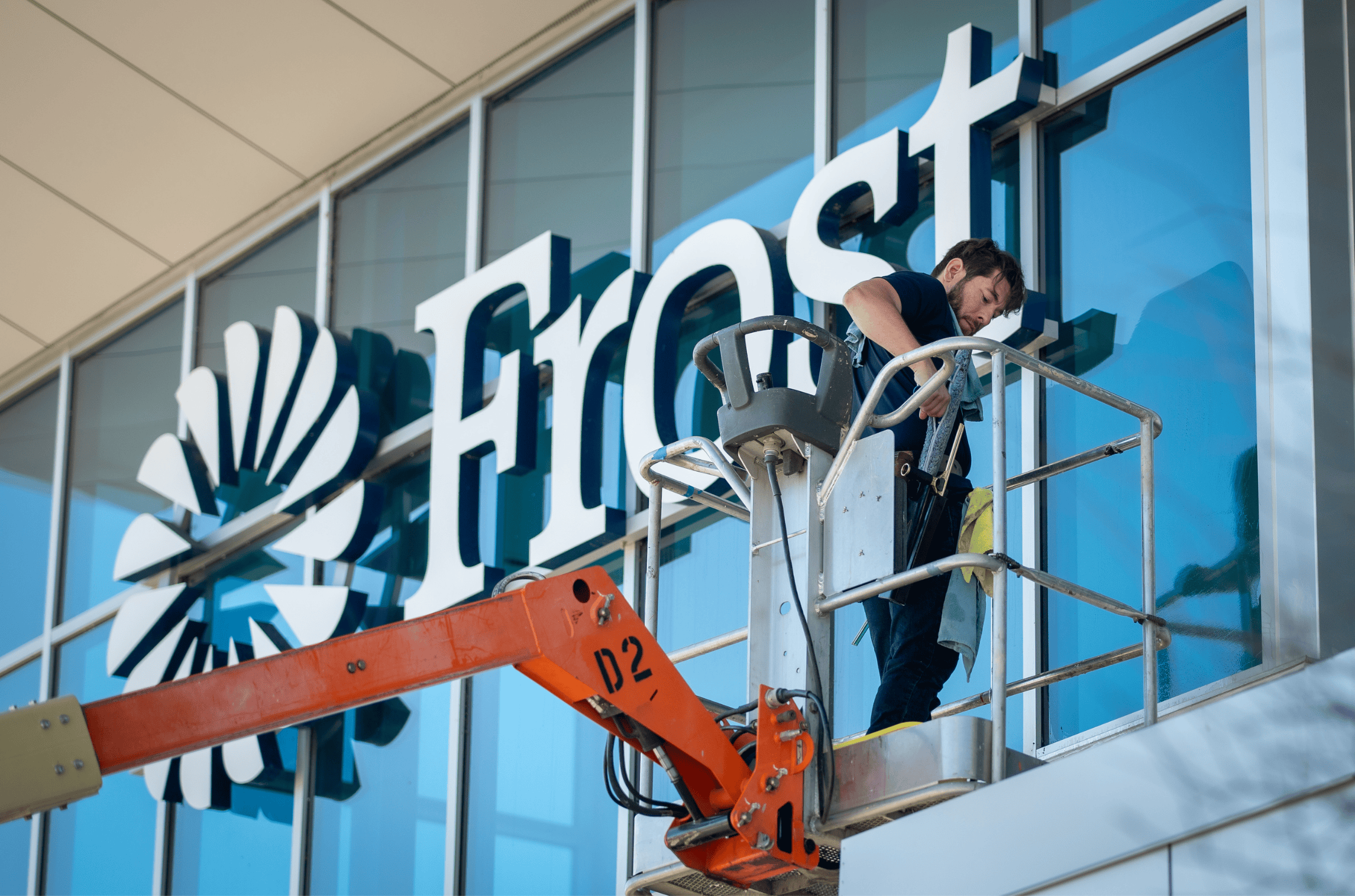 A worker in a bucket lift repairs the large