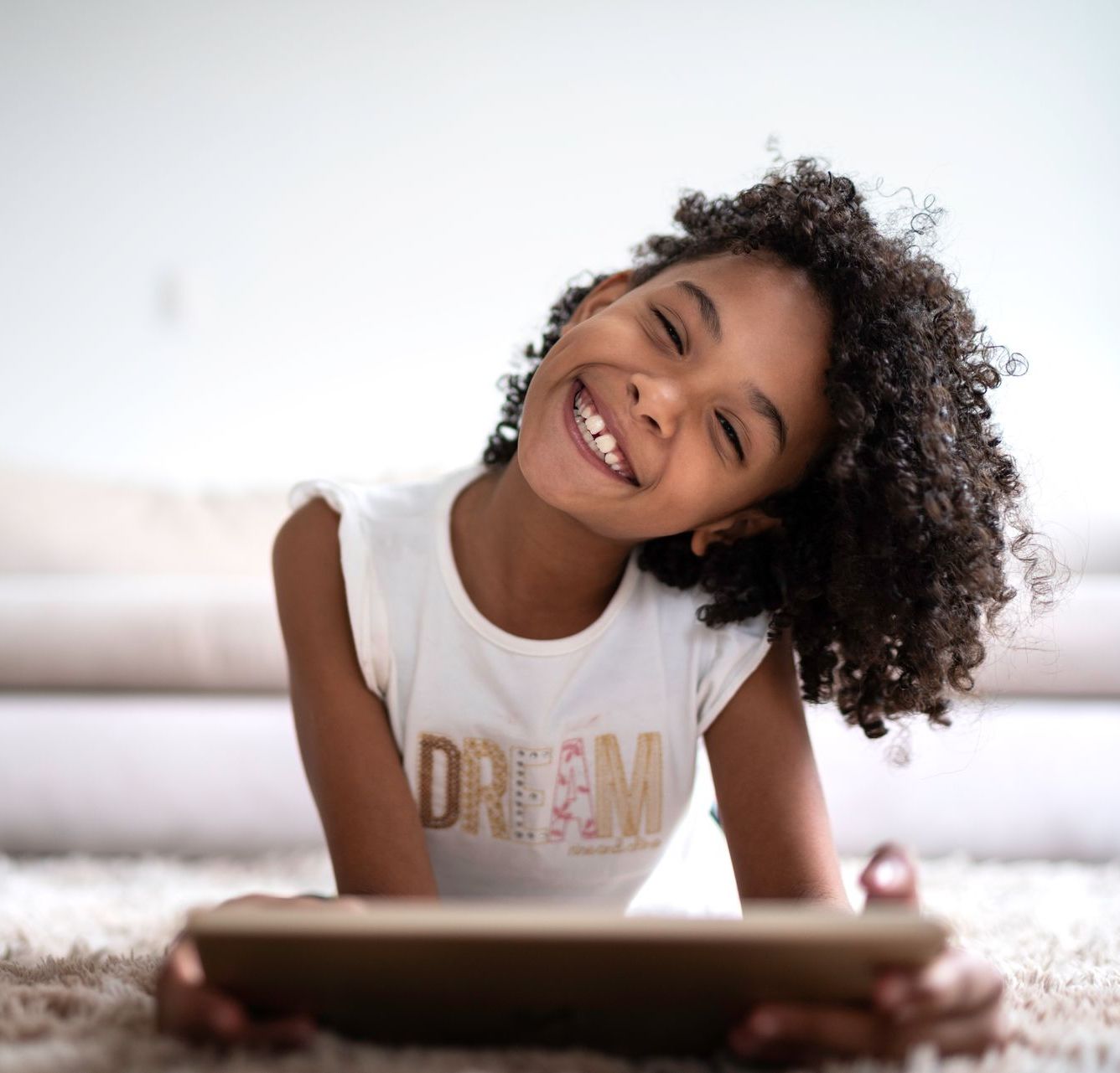 A girl is tilting her head and smiling