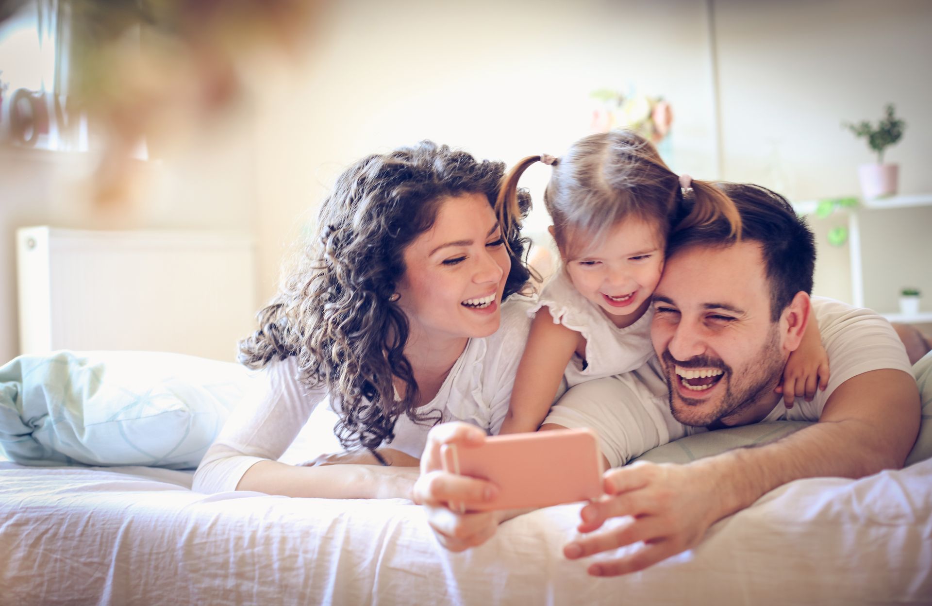 A smiling family is taking a selfie