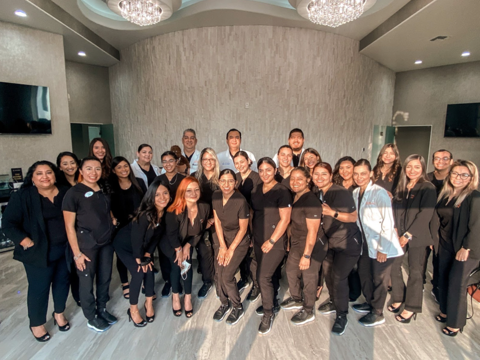 A large group of people are posing for a picture in a room.