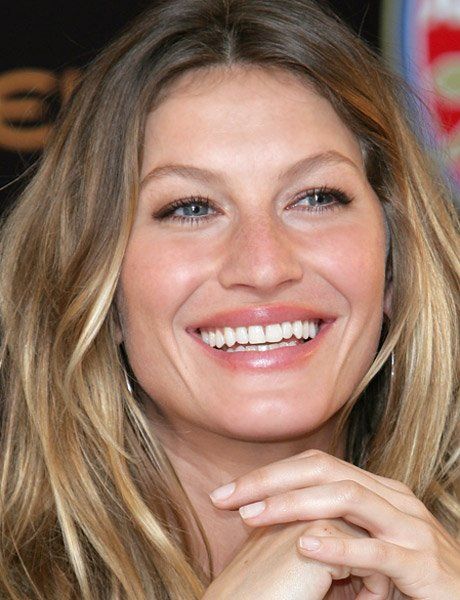 A close up of a woman 's face with a smile on her face