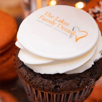 A chocolate cupcake with white frosting from the lakes family dental