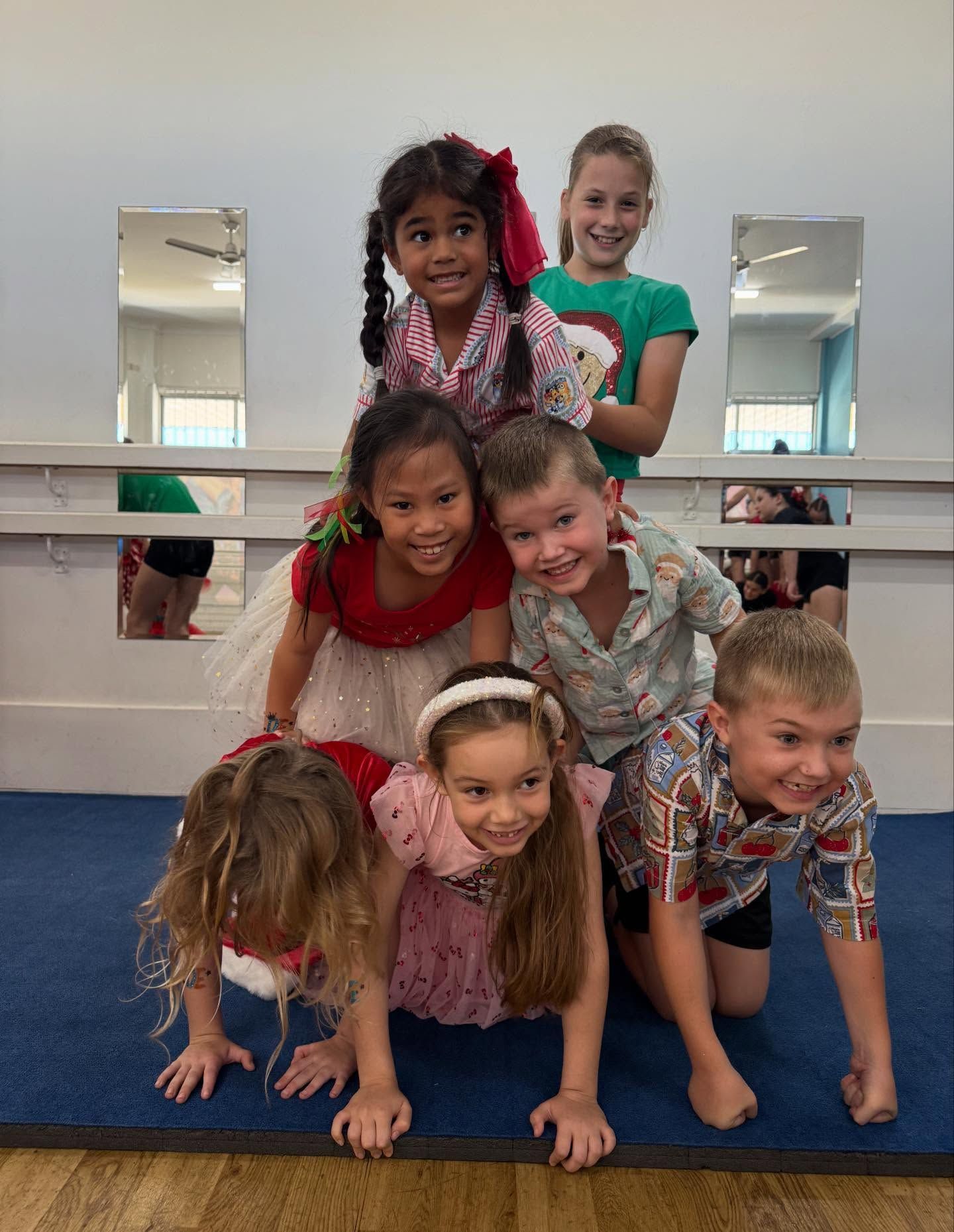 Seven Children Stacked in a Playful Human Pyramid — Dance Express Mackay In North Mackay, QLD