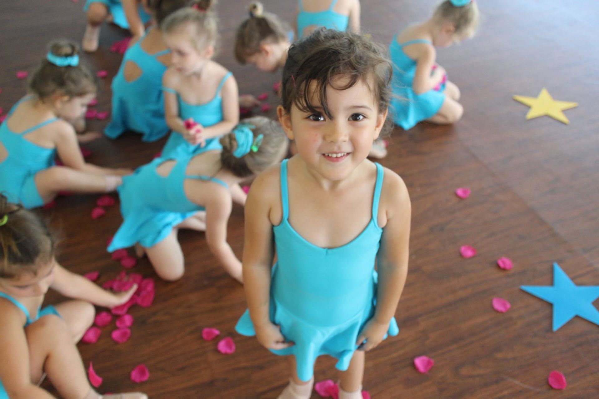 Smiling Child Holding a Colorful Bead Stack at a Lively Indoor Gym Event — Dance Express Mackay In North Mackay, QLD