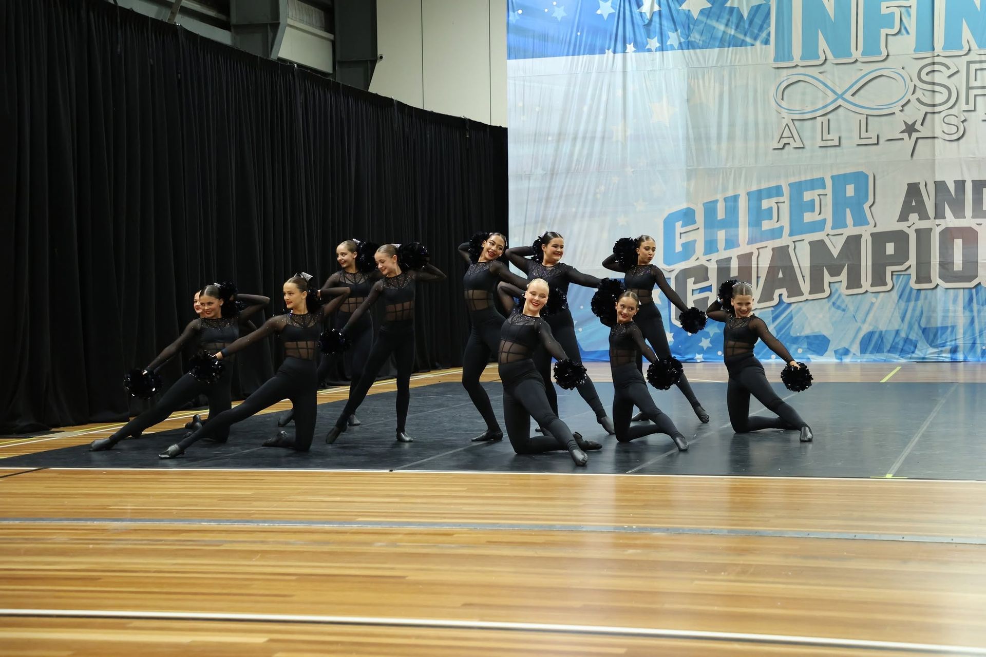 Group of Dancers in Black Uniforms Performing — Dance Express Mackay In North Mackay, QLD
