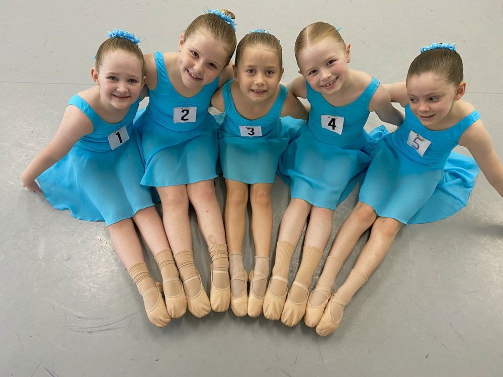 Five Young Girls in Blue Dresses and Ballet Shoes, Smiling and Posed Together — Dance Express Mackay In North Mackay, QLD