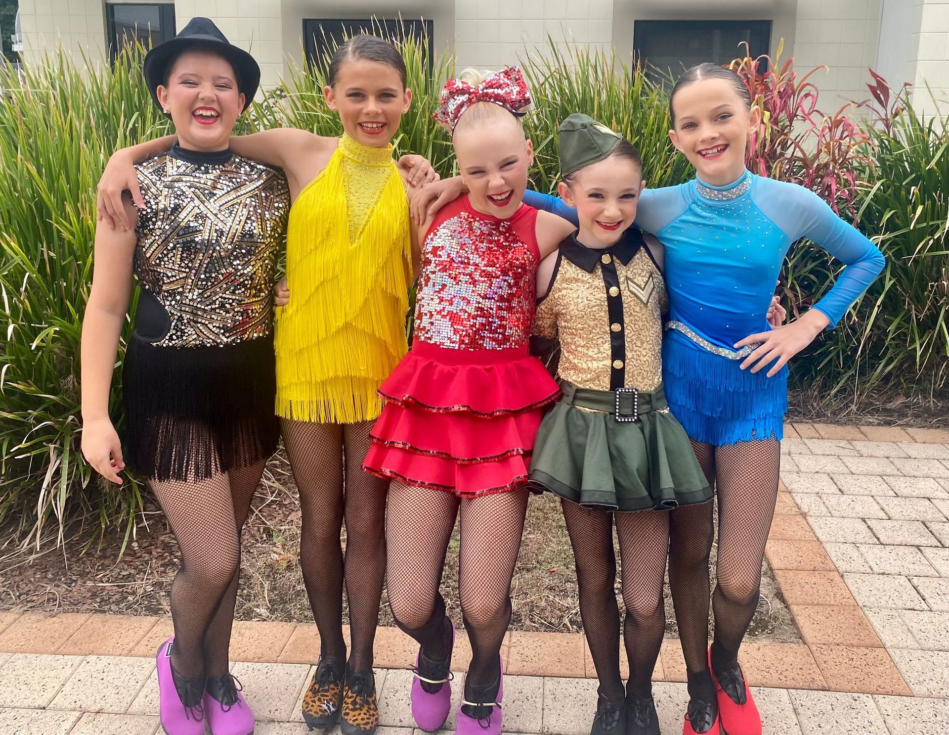 A Group Of Girls In A Picture In Front Of A Wall That Says 2025 Graduates — Dance Express Mackay In North Mackay, QLD