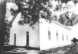 Small white church with trees beside it and an inset portrait of a man in the top right.