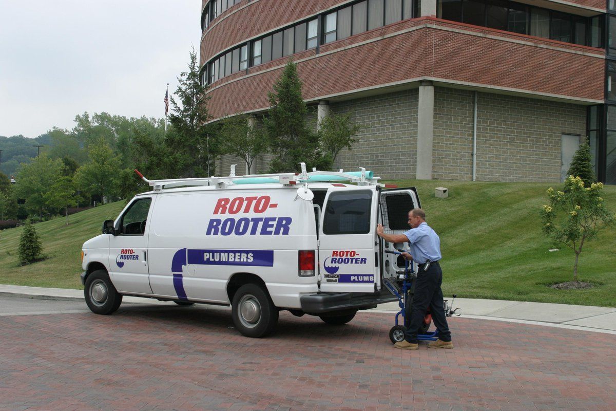 Roto-Rooter plumber outside commercial building