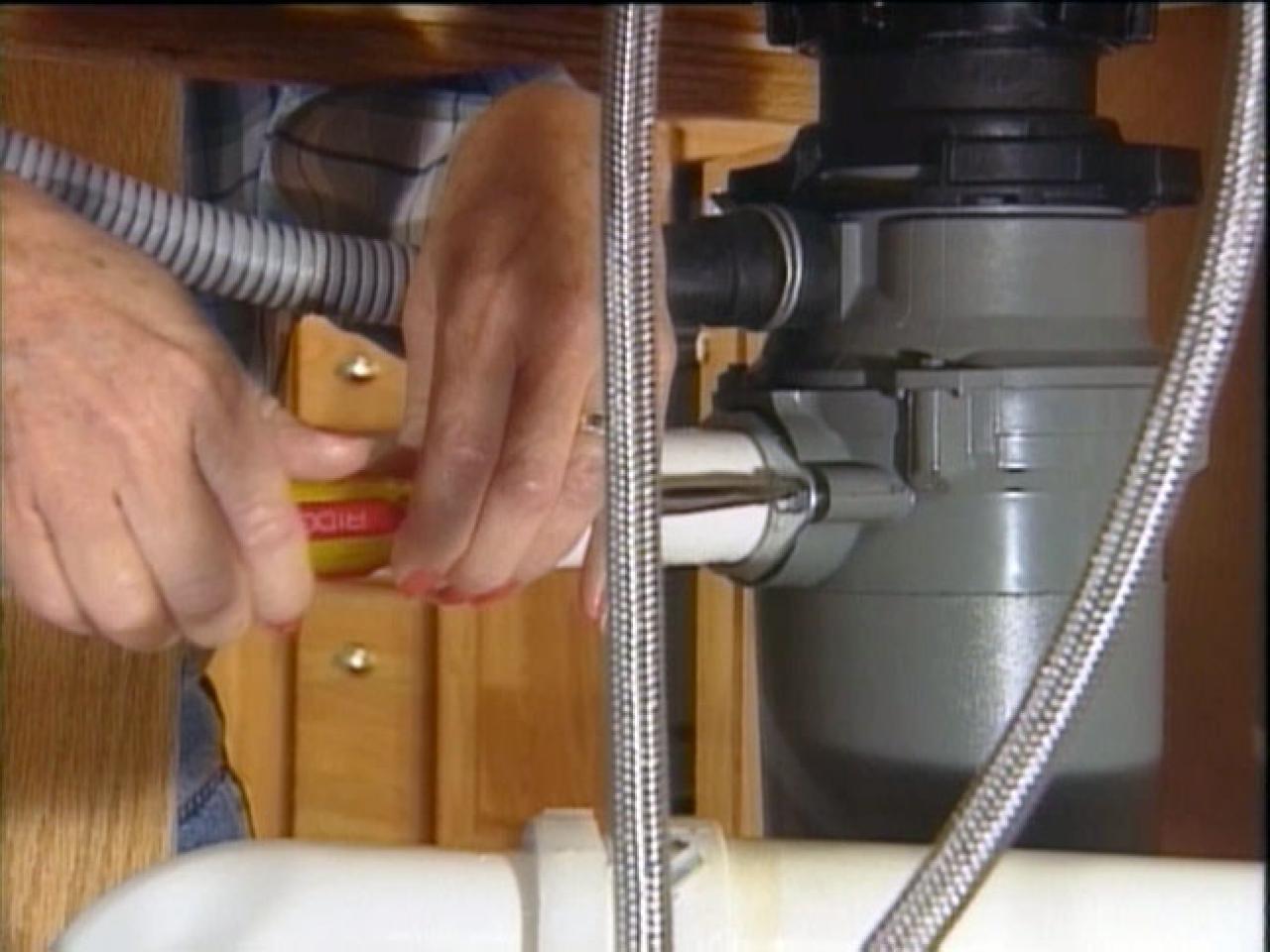 Roto-Rooter tech installing garbage disposal