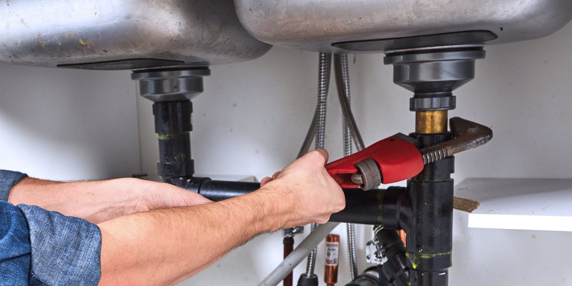 tech fixing commercial sink with wrench