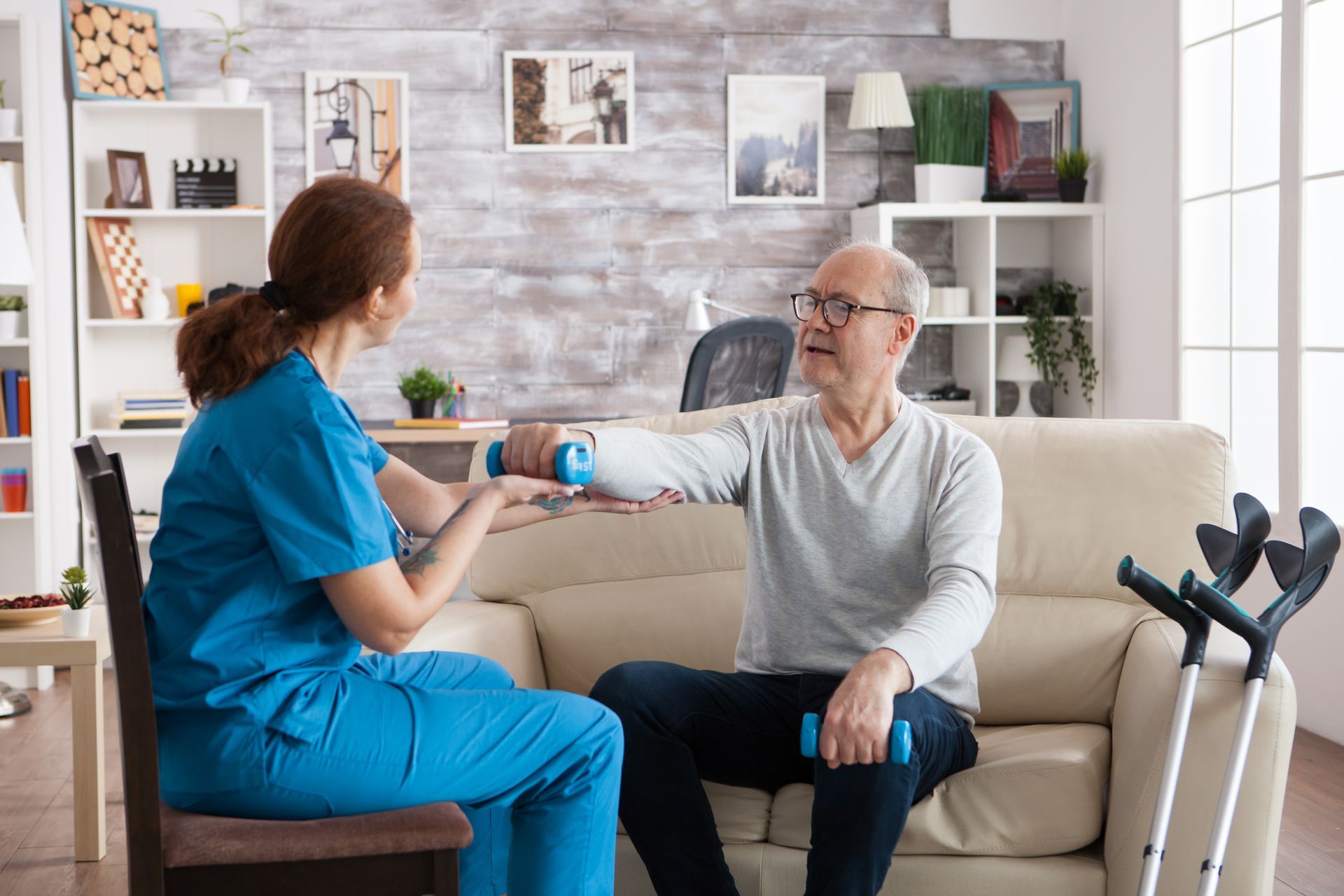 Therapist guiding patient doing upper body exercises.