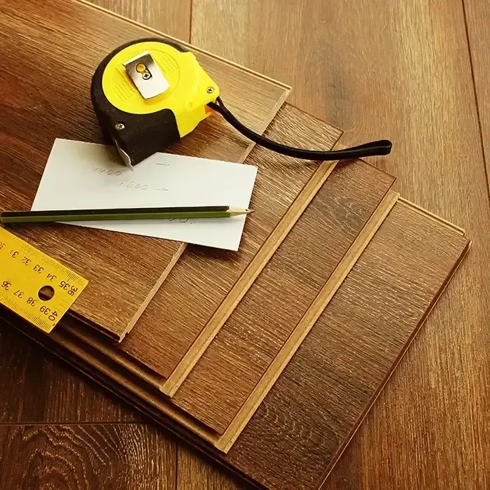 stacked flooring with tools for measuring